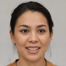 Joyful latino young-adult female with medium  brown hair and brown eyes