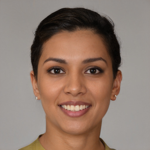 Joyful latino young-adult female with short  brown hair and brown eyes