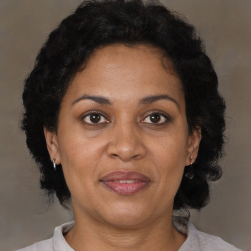 Joyful black adult female with short  brown hair and brown eyes