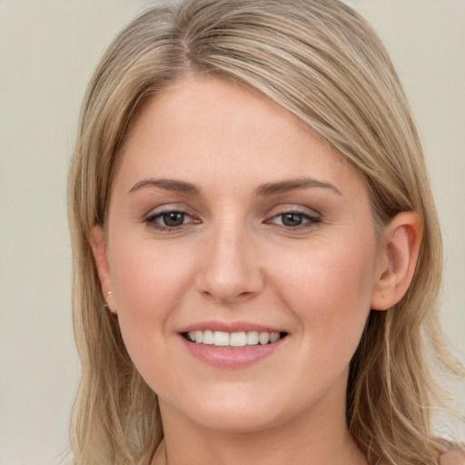 Joyful white young-adult female with long  brown hair and grey eyes