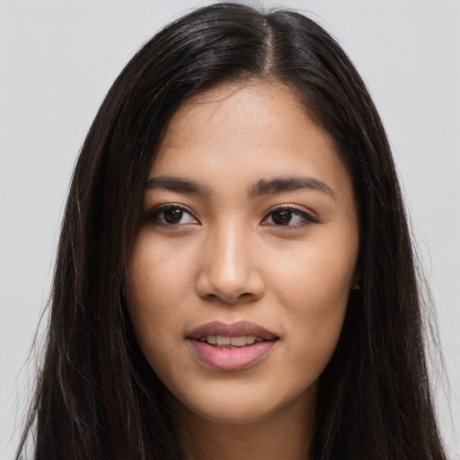 Joyful latino young-adult female with long  brown hair and brown eyes