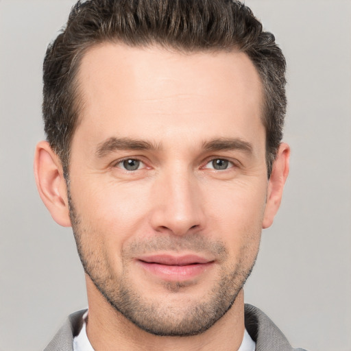 Joyful white young-adult male with short  brown hair and brown eyes