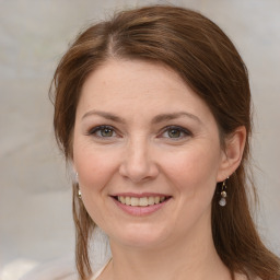 Joyful white adult female with medium  brown hair and blue eyes