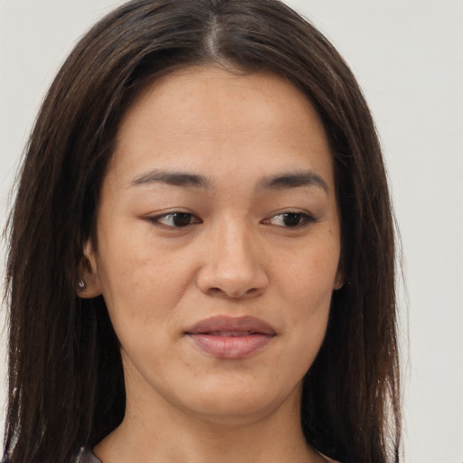 Joyful asian young-adult female with long  brown hair and brown eyes