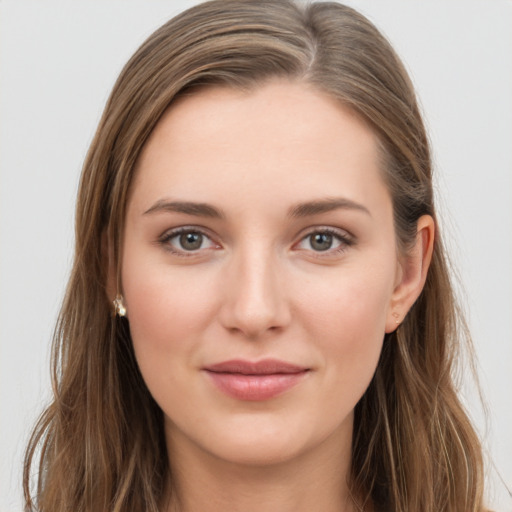 Joyful white young-adult female with long  brown hair and grey eyes