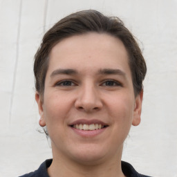 Joyful white young-adult female with short  brown hair and grey eyes