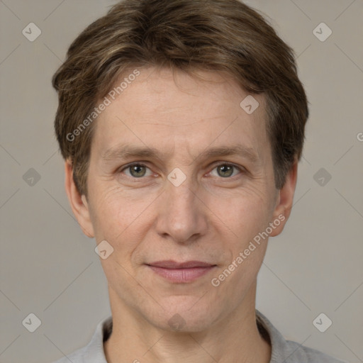 Joyful white adult male with short  brown hair and grey eyes