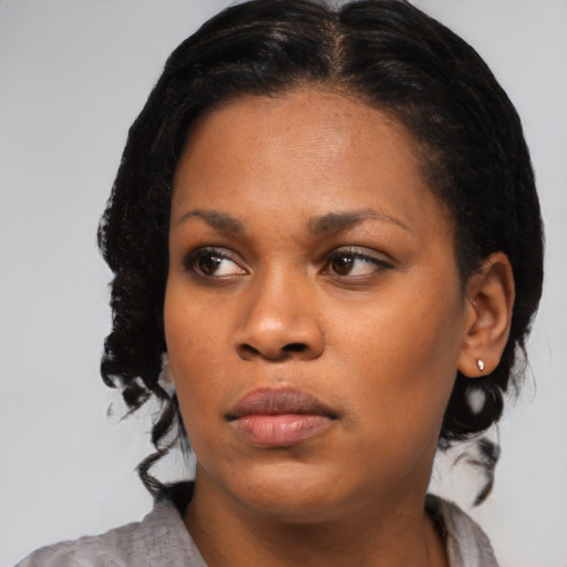 Neutral black young-adult female with medium  brown hair and brown eyes