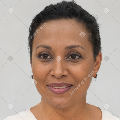 Joyful latino adult female with short  brown hair and brown eyes