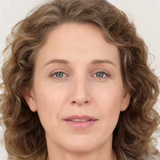 Joyful white young-adult female with long  brown hair and green eyes