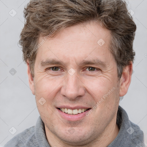 Joyful white adult male with short  brown hair and grey eyes