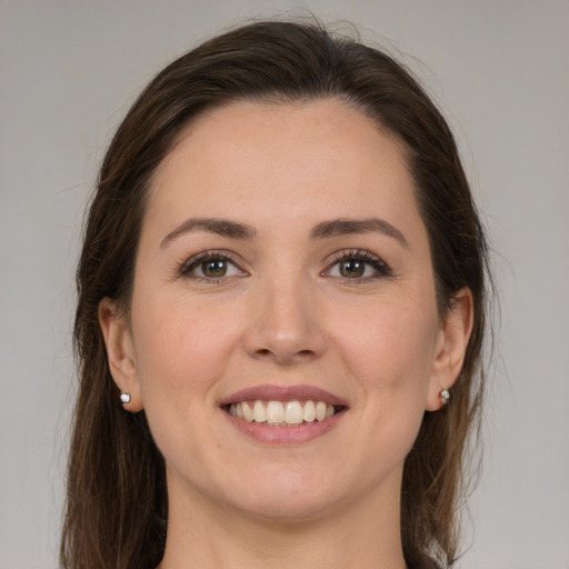 Joyful white young-adult female with medium  brown hair and brown eyes