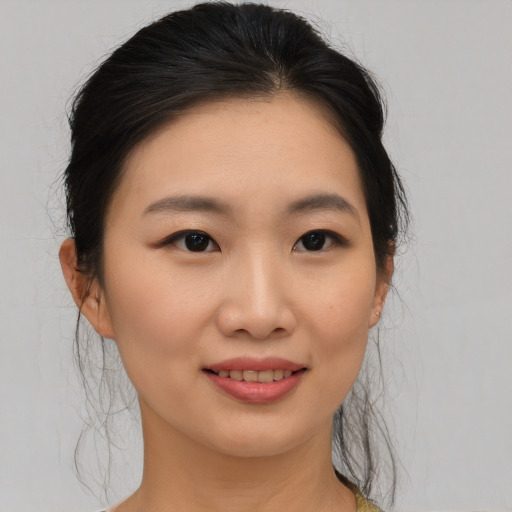 Joyful asian young-adult female with medium  brown hair and brown eyes