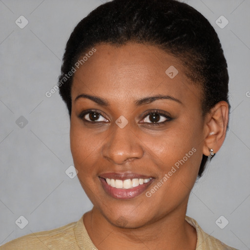 Joyful black young-adult female with short  black hair and brown eyes