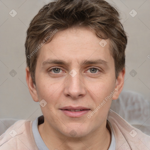 Joyful white adult male with short  brown hair and grey eyes