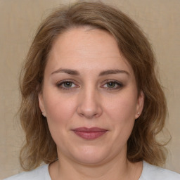 Joyful white adult female with medium  brown hair and brown eyes