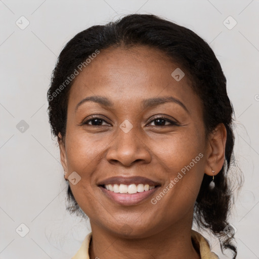 Joyful black adult female with medium  brown hair and brown eyes