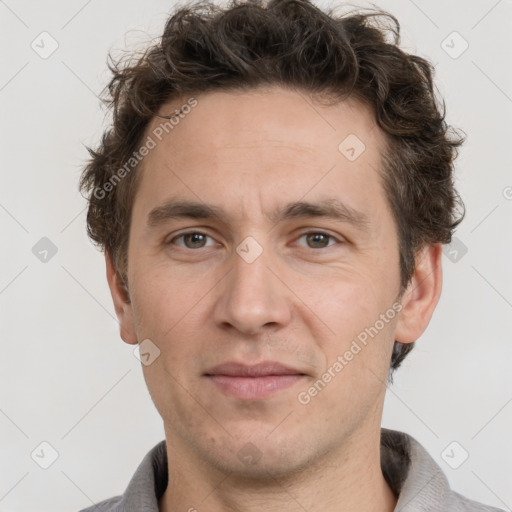 Joyful white adult male with short  brown hair and grey eyes