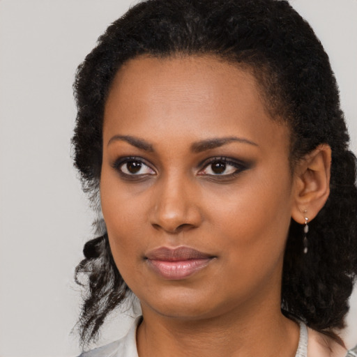Neutral black young-adult female with long  brown hair and brown eyes