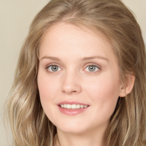 Joyful white young-adult female with long  brown hair and green eyes