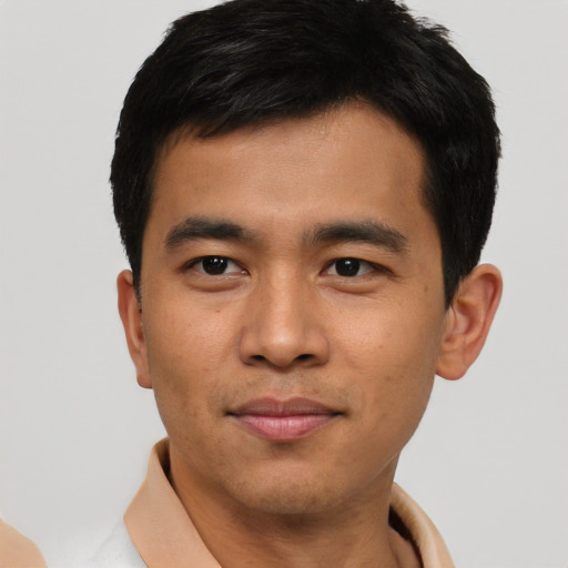 Joyful asian young-adult male with short  black hair and brown eyes