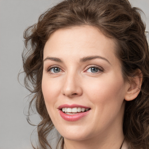 Joyful white young-adult female with medium  brown hair and green eyes