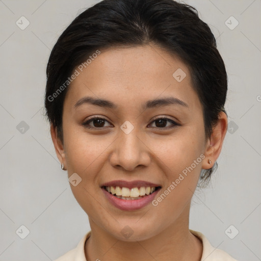 Joyful asian young-adult female with short  brown hair and brown eyes