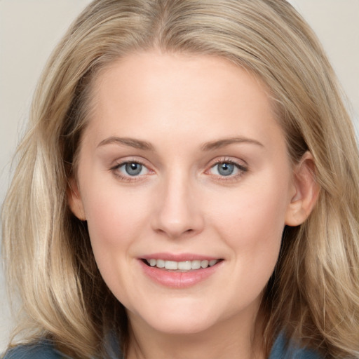 Joyful white young-adult female with long  brown hair and blue eyes