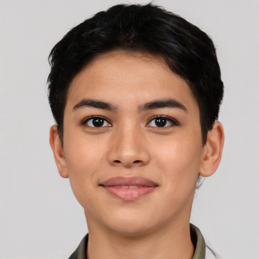 Joyful latino young-adult male with short  black hair and brown eyes