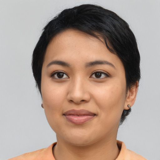 Joyful latino young-adult female with medium  black hair and brown eyes
