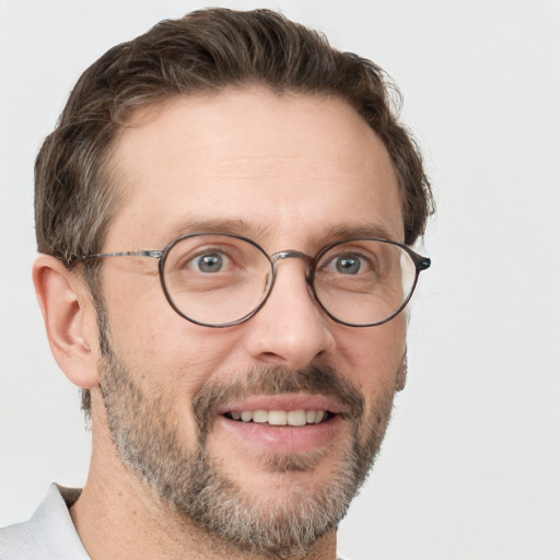 Joyful white adult male with short  brown hair and grey eyes