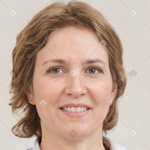 Joyful white adult female with medium  brown hair and grey eyes