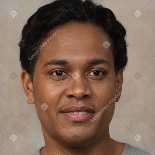 Joyful black young-adult male with short  black hair and brown eyes