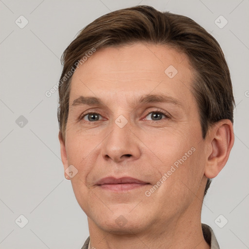 Joyful white adult male with short  brown hair and grey eyes