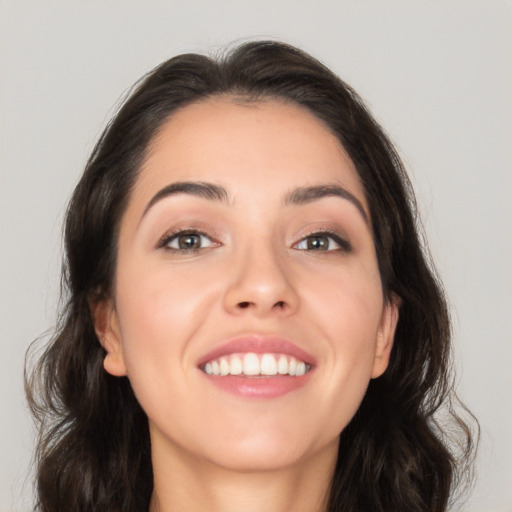 Joyful white young-adult female with long  brown hair and brown eyes