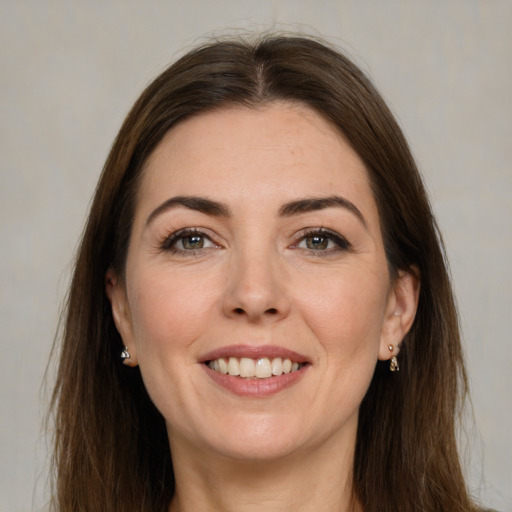 Joyful white young-adult female with long  brown hair and grey eyes