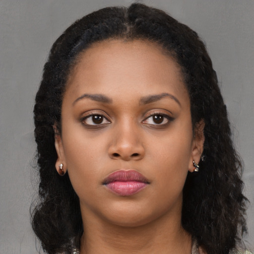 Neutral black young-adult female with long  brown hair and brown eyes