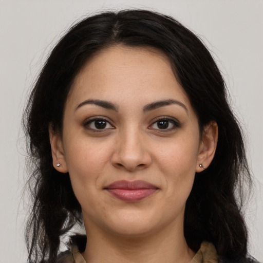 Joyful latino young-adult female with long  brown hair and brown eyes