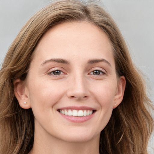 Joyful white young-adult female with long  brown hair and grey eyes