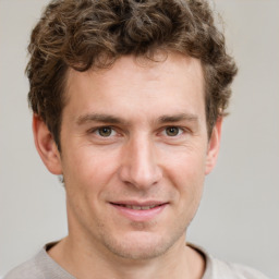 Joyful white adult male with short  brown hair and grey eyes