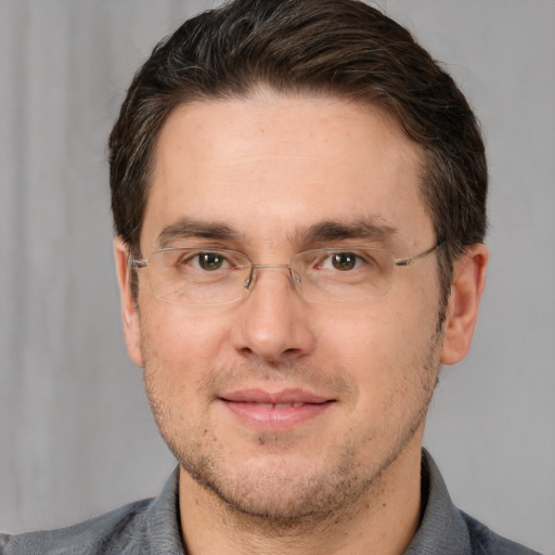 Joyful white adult male with short  brown hair and brown eyes