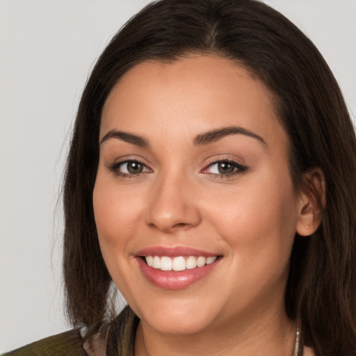 Joyful white young-adult female with long  brown hair and brown eyes