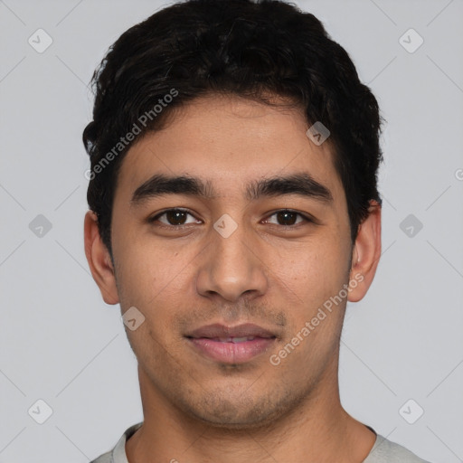 Joyful white young-adult male with short  black hair and brown eyes