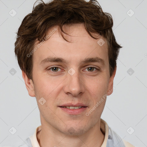 Joyful white adult male with short  brown hair and grey eyes