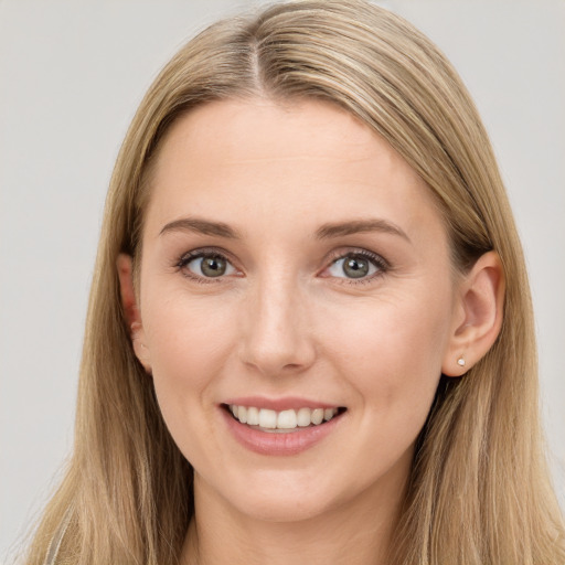 Joyful white young-adult female with long  brown hair and grey eyes