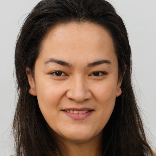 Joyful white young-adult female with long  brown hair and brown eyes