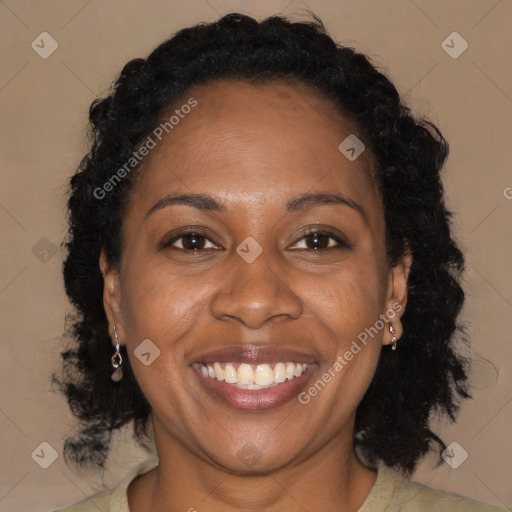 Joyful black adult female with medium  brown hair and brown eyes