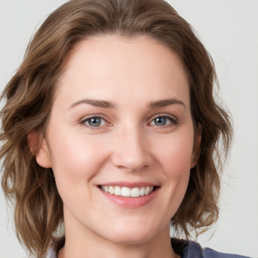 Joyful white young-adult female with medium  brown hair and blue eyes