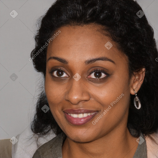 Joyful black young-adult female with long  brown hair and brown eyes