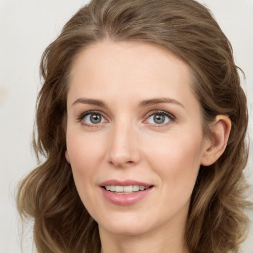 Joyful white young-adult female with long  brown hair and green eyes